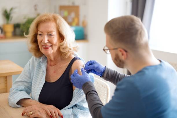 istock Caregiver vaccinating a woman 2148809218
