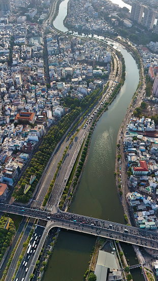 Ho chi Minh city aerial view with canal system, overcrowded riverside urban, Vo Van Kiet avenue along Tau Hu canal, dense density and crowded townhouse of big Asian town, Saigon, Viet Nam