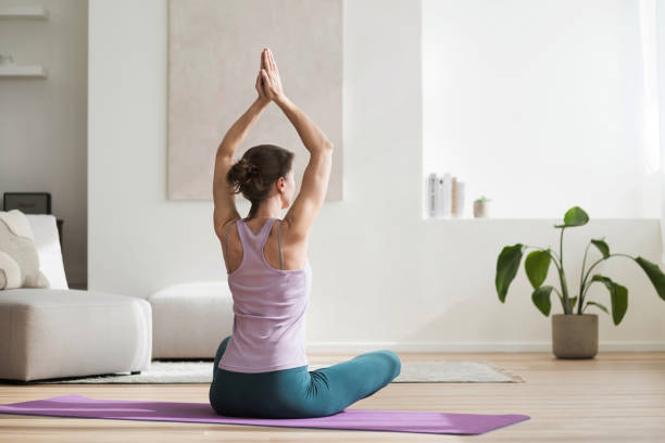 istock Woman doing practicing yoga and relaxation exercises, meditating at home 2148811353