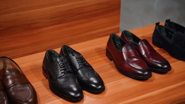 Variety of men's dress shoes on shelf