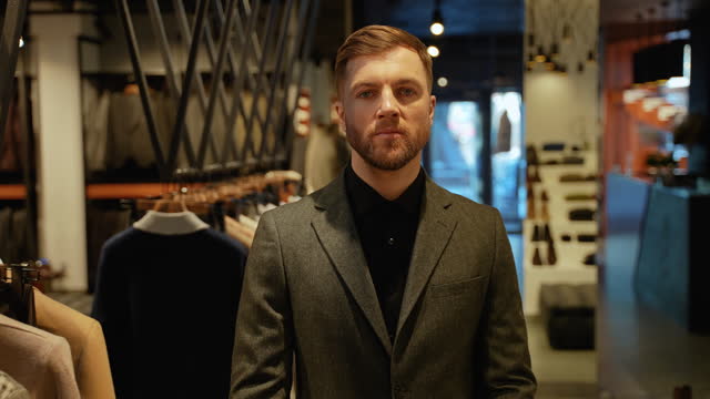 Handsome man walking in clothing store
