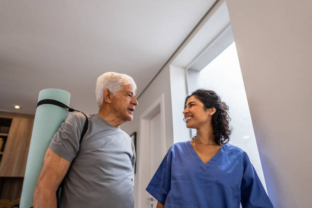 istock Physiotherapist talking to a senior patient at house 2148812202