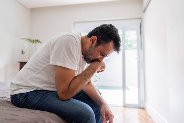 istock Worried mature man sitting on bed at home 2148812583