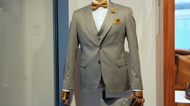 Mannequins with premium men's suit in the boutique. Clothing store
