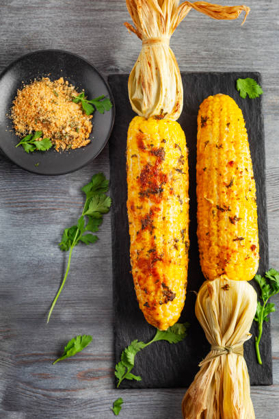 Grilled Corn Cob with Herbs and Cheese. Corn On The Cob. Corn. Sweet yellow corn. Fresh corn with spice. Barbecue and grilled corn with cheese.