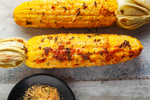 Corn On The Cob. Grilled. Baked. Butter. Corn. Food and drink. Appetizer. Barbecue - Meal. Butter. Cheese.  Roasted