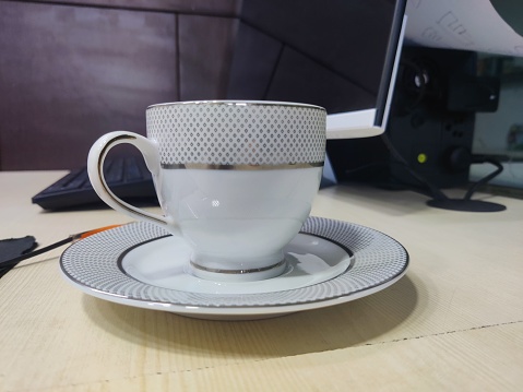 Antique tea cup in India. Special office edition with corporate work scenario background.