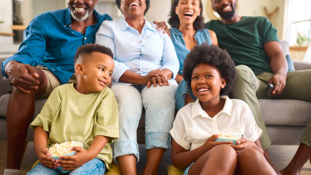 istock Multi-Generation Family Sitting On Sofa At Home Watching TV Together 2148813913