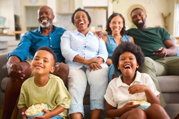 istock Multi-Generation Family Sitting On Sofa At Home Watching TV Together 2148814069