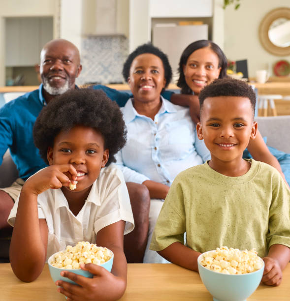 istock Multi-Generation Family Sitting On Sofa At Home Watching TV Together 2148814173