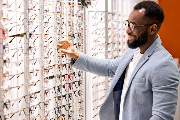 istock Handsome young smiling bearded african man buying eyeglasses at optics 2148816031