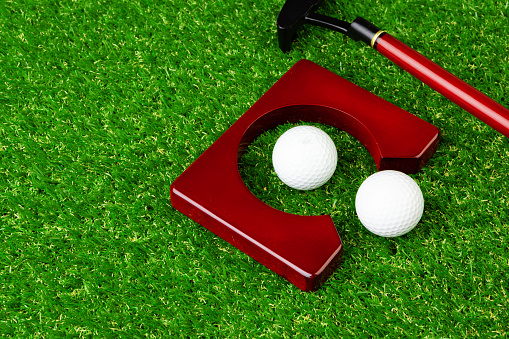 Mini golf equipment on grass close up