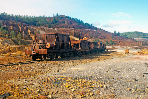 rusty mine cart abandoned on a track, taken in La Naya site, Huelva province in Andalucía,  Spain.