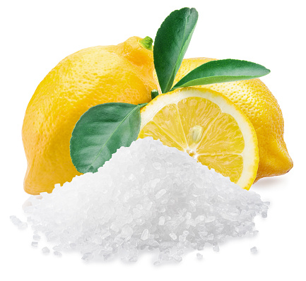 Citric acid powder with ripe lemon fruits isolated on white background.