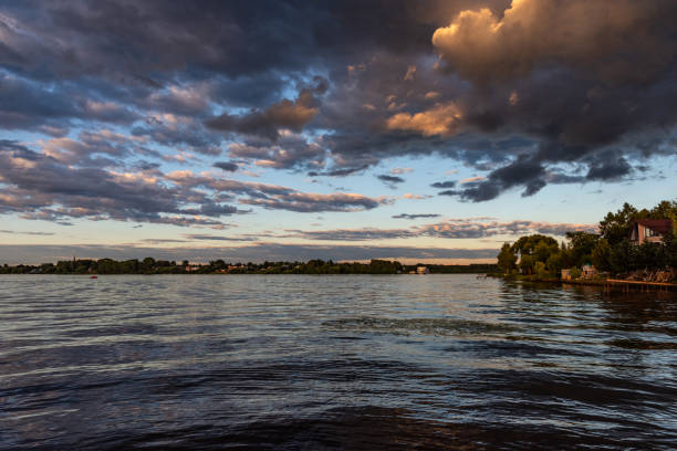 Beautiful panoramic view of sunset on the Volga River. Picturesque sunset landscape on the river. Dramatic sky.