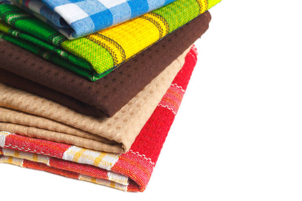 The stack of colorful kitchen towels. Textile dish wipe clothes isolated on white with copy space area for design elements.