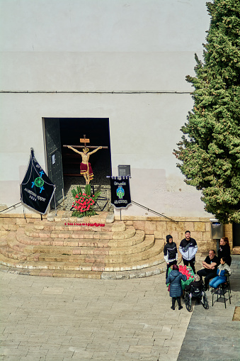 Tarragona, Spain - April 16, 2024: A religious gathering of the gypsy community s Holy Week framed by ancient architecture where spirituality and brotherhood intertwine in serene ambiance.