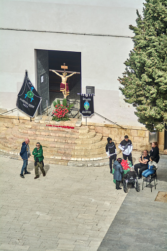 Tarragona, Spain - April 16, 2024: The gypsy community gathered around a religious artistic representation during Holy Week, creating a solemn and spiritual atmosphere reflecting their shared faith.