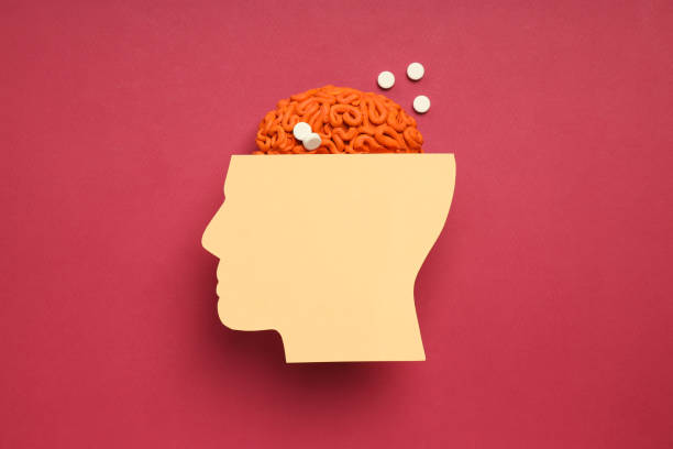 Paper head with decorative brain on red background