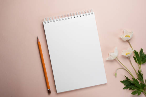 istock Floral flat lay with anemone flowers, notebook blank on a beige background. Mockup, copy space. 2148819798