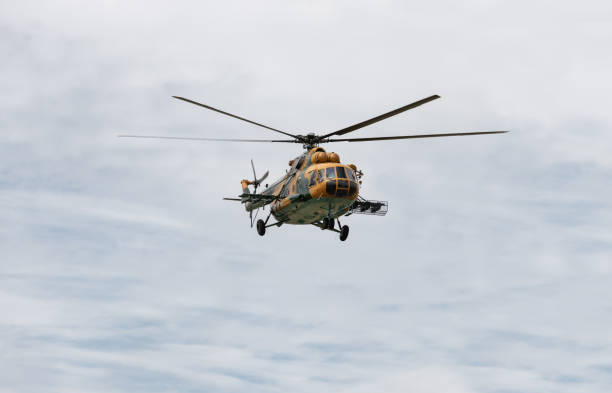 istock Military helicopter in the cloudy sky. 2148822305