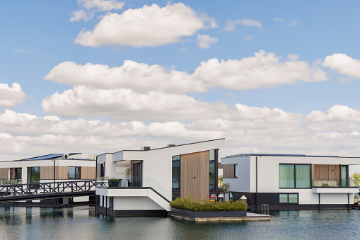 Nijmegen, The Netherlands - April 10, 2024: New white contemporary house boats in Nijmegen, The Netherlands