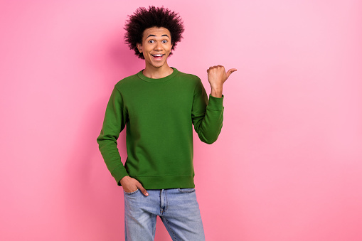 Photo of happy positive guy impressed discount adverts point empty space isolated pastel color background.