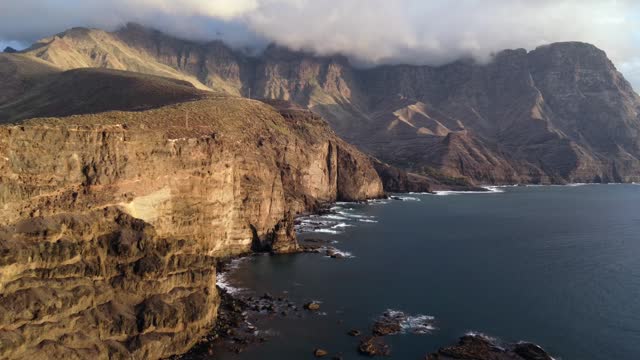 Aerial view of the cliffs and coast of Agaete at summer sunset in Gran Canaria. Spain