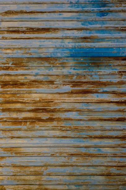 istock Vertical blue gray corrugated steel fence or wall surface with orange rust marks 2148827166