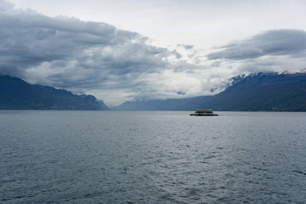 istock Small towns around a lake surrounded by cloud-covered Alps. 2148827236