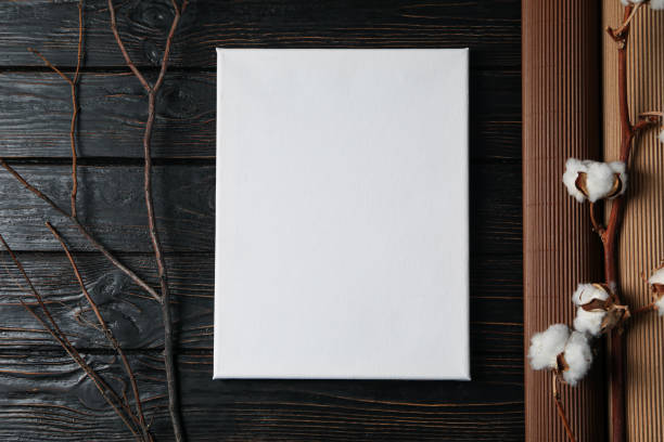 istock Canvas on a black background, with a branch and cotton 2148827286