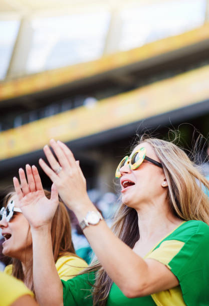istock Sports fans: joyful soccer supporters react to match action in a stadium 2148827325