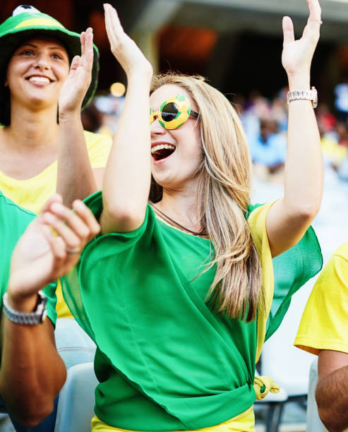 istock Sports fans: joyful soccer supporters react to match action in a stadium 2148827537