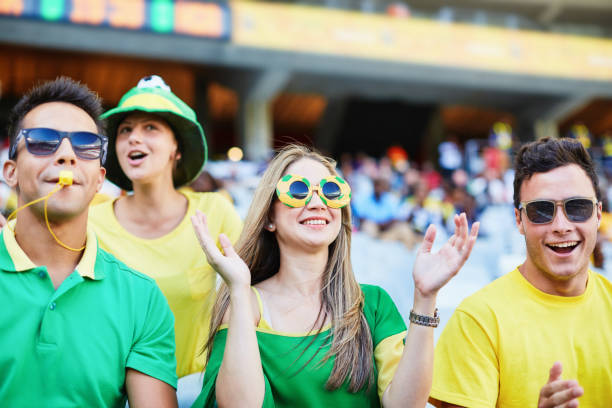 istock Sports fans: joyful soccer supporters react to match action in a stadium 2148827557