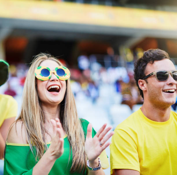 istock Sports fans: joyful soccer supporters react to match action in a stadium 2148827593