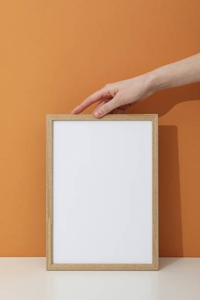 istock Hand holding a photo frame on a brown background 2148827672