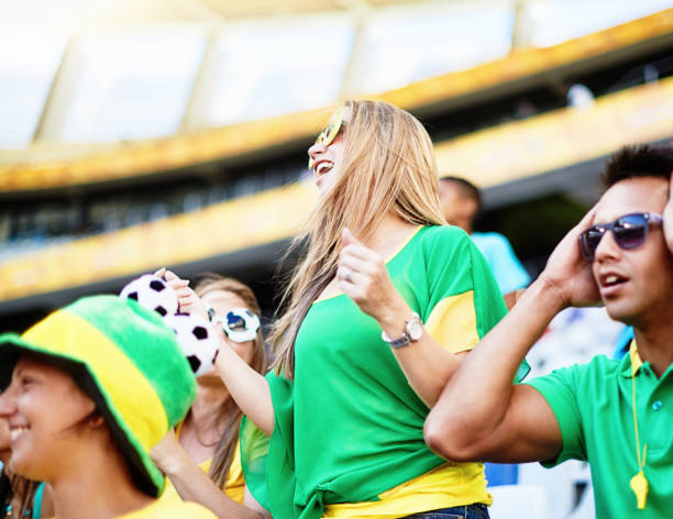 istock Sports fans:  soccer supporters react to match action in a stadium 2148827683