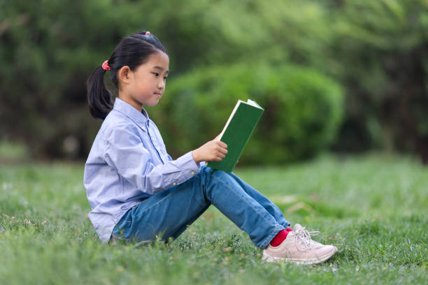 istock Little Girl Reading Book 2148828919