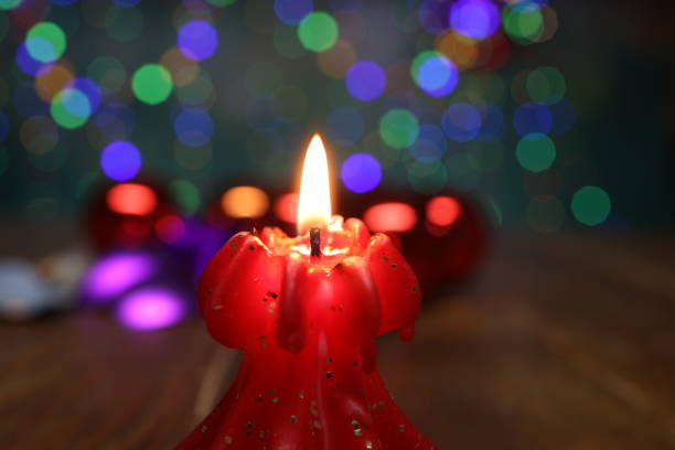 New Years motive. Burning candle on a blurred background.