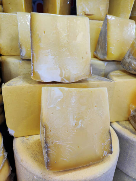 istock Delicious yellow cheese, cut into chunks, on the shop window 2148829251