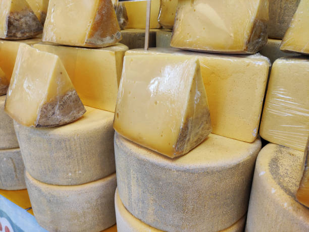istock Delicious yellow cheese, cut into chunks, on the shop window 2148829302