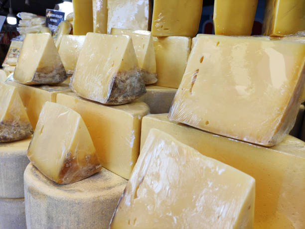istock Delicious yellow cheese, cut into chunks, on the shop window 2148829361
