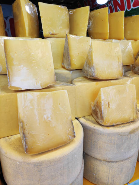 istock Delicious yellow cheese, cut into chunks, on the shop window 2148829362
