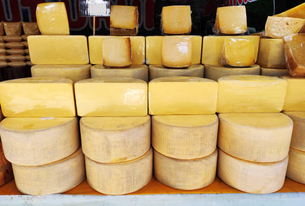 istock Delicious yellow cheese, cut into chunks, on the shop window 2148829677