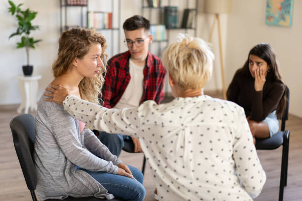 istock A counsellor supporting a young woman with a hand on the woman's shoulder 2148833621