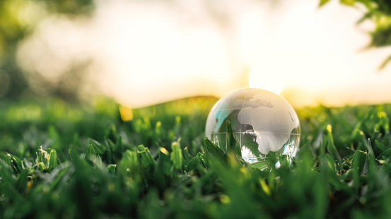 B roll - Glass crystal globe on the green grass nature in sunset, concept for environment and conservatio