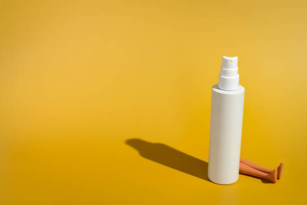 istock Blank white spray bottle with doll legs in direct sunlight 2148834210