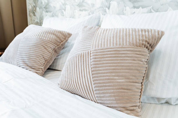 istock A comfortable wooden bed with white linens and pillows in a rectangle room 2148834758