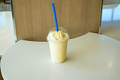 Picture of a ready-to-drink milk shake mixed with bananas on the dining table.