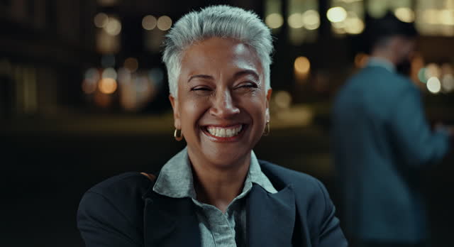 Business woman, city and smile at night for travel, commute and excited for legal career, job or news. Excited face or portrait of boss, CEO or senior lawyer outdoor with confidence in bokeh lights